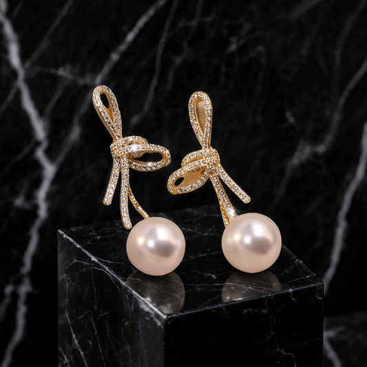 Celinea – Pendientes de lazo dorado con perla luminosa
